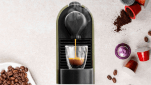 nespresso-machine-pouring-hot-coffee-on-a-white