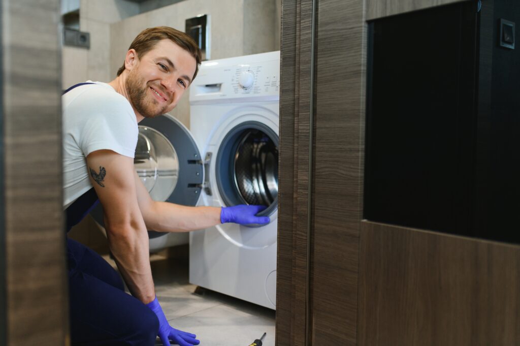 Technician repairing a washing machine